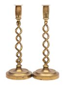 A pair of 19th century brass candlesticks: with plain cylindrical sconces on spiral twist stems and