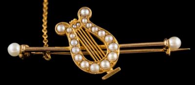 A late 19th century split pearl lyre brooch: the lyre set with split pearls on a bar with a pearl