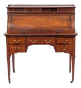 An Edwardian mahogany and inlaid cylinder fronted writing desk:, bordered with ebony lines,
