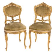 A pair of late 19th Century French carved giltwood salon chairs:,