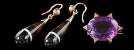 A late 19th century gold and amethyst single-stone brooch: the oval cut amethyst in a chunky claw