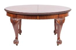 A carved mahogany oval dining table in the George II taste,
