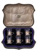 A set of six George V silver mounted tots, maker Wakely & Wheeler, London,