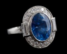 A sapphire and diamond ring: the central oval cut sapphire, stated to weigh 7.