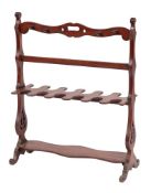 A 19th Century mahogany boot and whip rack:, the shaped top with carrying handle and eight hooks,