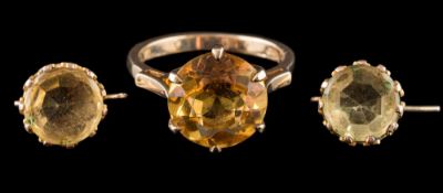A 1970s 9 carat gold citrine dress ring: the circular cut citrine in a claw setting,