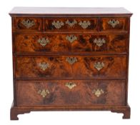 An early 18th Century walnut and feather banded chest:, with a wide crossbanded moulded top,