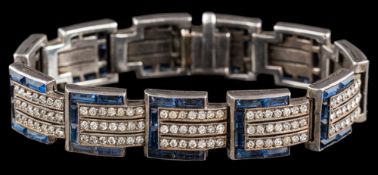 An Art Deco paste bracelet: the articulated panels set with circular cut white paste and
