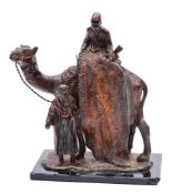An Austrian cold painted spelter style table lighter: modelled as an Arab carpet seller with camel,