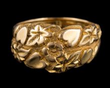 A gold coloured ring: with flower and heart detail, ring size M,