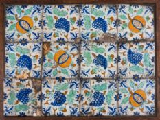 A set of twelve mid 17th century Dutch polychrome delftware tiles: painted with pomegranates,