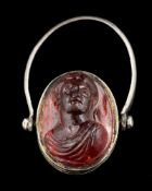 A hessonite garnet cameo swivel ring: the oval hessonite garnet carved with a lady,