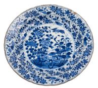 A Chinese blue and white charger: the centre painted with two peacocks, peonies,