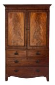 A late Georgian mahogany linen press:, adapted as a gentleman's wardrobe,