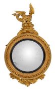 A Regency carved giltwood circular convex mirror:,