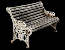 A cast iron and white painted lath garden bench seat:, of curved outline,