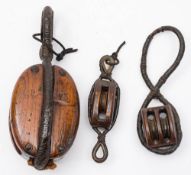A ship's wooden single block with rope strop: stamped 'P73' to cheek together with a smaller single