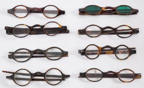 Eight pairs of 19th century tortoiseshell framed spectacles: including one pair with green tinted