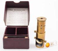 A small lacquered brass 'The Microscope': of two sections in a fitted case with instructions and