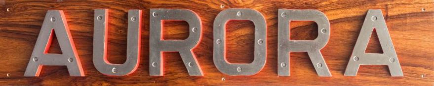 The cast bronze ship's name plate letters from the Royal Navy Leader-class frigate HMS Aurora