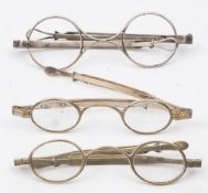 A pair of early 19th century silver spectacles: with clear oval lenses and extending frames ,