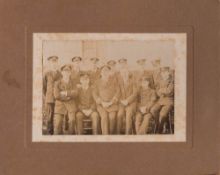 A card mounted sepia photograph of F E Davies and a group of unidentified RN officers: F E Davies