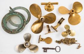 Three small bronze propellers: together with a porthole, brass blocks and related metalware.