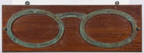 An early 20th century oak optician's shop sign: in the form of a pair of brass oval spectacle