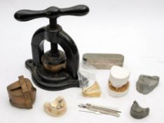 A group of late 19th/early 20th century dental instruments: comprising a cast iron dental press