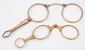 A pair or yellow metal lorgnettes with scroll chased decoration: and a pair of gold plated