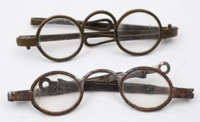 A pair of early 19th century paktong spectacles:, circular clear lenses and folding arms,