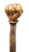 A 19th century marine ivory walking cane with carved pommel in the form of a fist holding a snake: