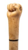 A 19th century marine ivory walking cane with carved pommel in the form of a fist: over a three