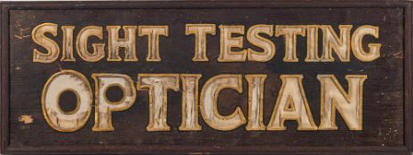 An early 20th century oak sign 'Sight Testing Optician': the text cut from an oak base and