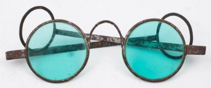 A pair of Georgian steel framed spectacles: with circular cyan coloured glass,