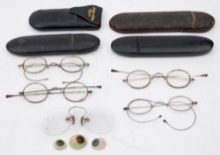 Four pairs of steel framed spectacles: including a pair in a gilt decorated mache case,