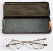 A pair of early 20th century German white metal spectacles: with octagonal lenses and extending