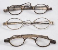 Three pairs of 19th century silver spectacles with folding arms.