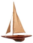 An early 20th Century style pond yacht:, the fully rigged sails over single piece laminated deck,