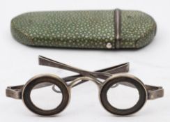 A pair of white metal 'Martin's Margins' spectacles: the lenses within horn mounts,
