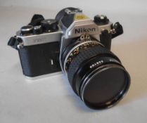 A Nikon FM2 35mm SLR camera: fitted with a Nikkor 55mm 1:2.8 lens, No 368700.