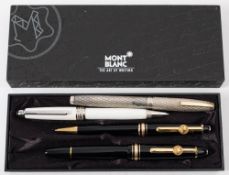 A Mont Blanc fountain pen and biro set: in black with gold bands,