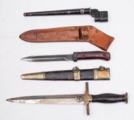 A British No 4 Mk 1 spike bayonet: with steel scabbard, a German replica dagger and a short bayonet.