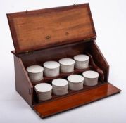 A late 19th century mahogany apothecary's box: the sloping front enclosing two shelves with white