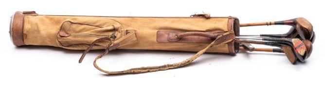 A set of early to mid-20th century golf clubs and riding crop.