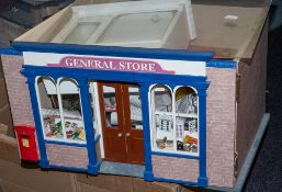 A 20th Century doll's shop 'General Store' with fitted interior, figures and accessories.