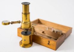 A late 19th century student's brass monocular microscope: sliding focus with single objective and