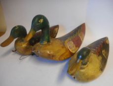 A set of three graduated carved wooden and polychrome decorated Mallard duck decoys: 34cm, 32cm,