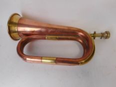 A Boosey & Hawkes 400 cooper and brass bugle: complete with mouthpiece.