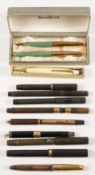 A group of nine vintage fountain pens: including a Waterman's 9ct gold mounted pen with
